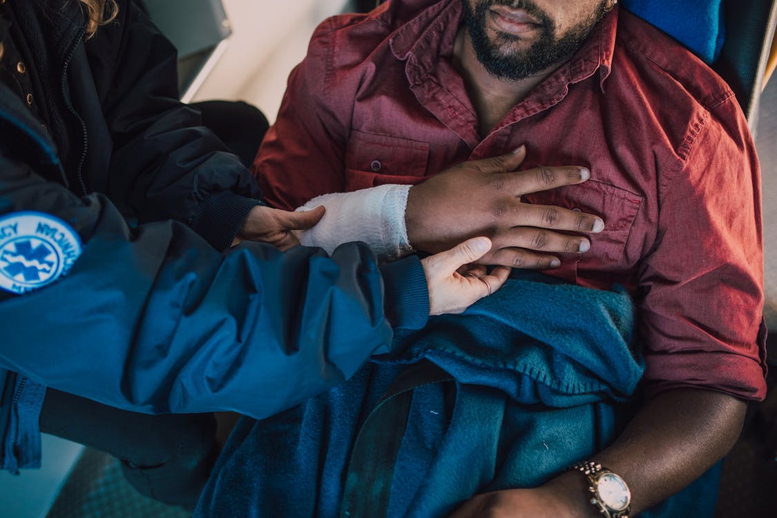 emergency medical technician assisting accident victim emergency medical technician assisting accident victim