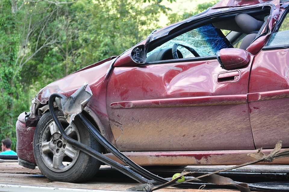 heavily damaged car on flat bed truck heavily damaged car on flat bed truck