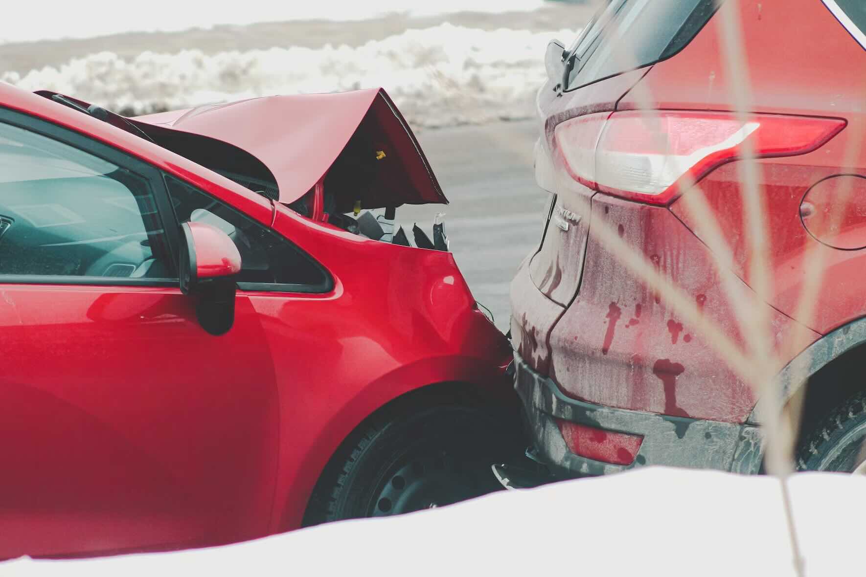 aftermath of collision between two red cars