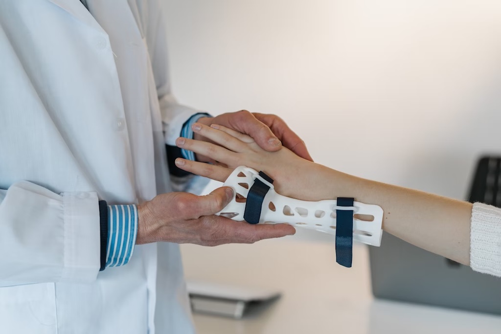A doctor putting a brace on a person's wrist